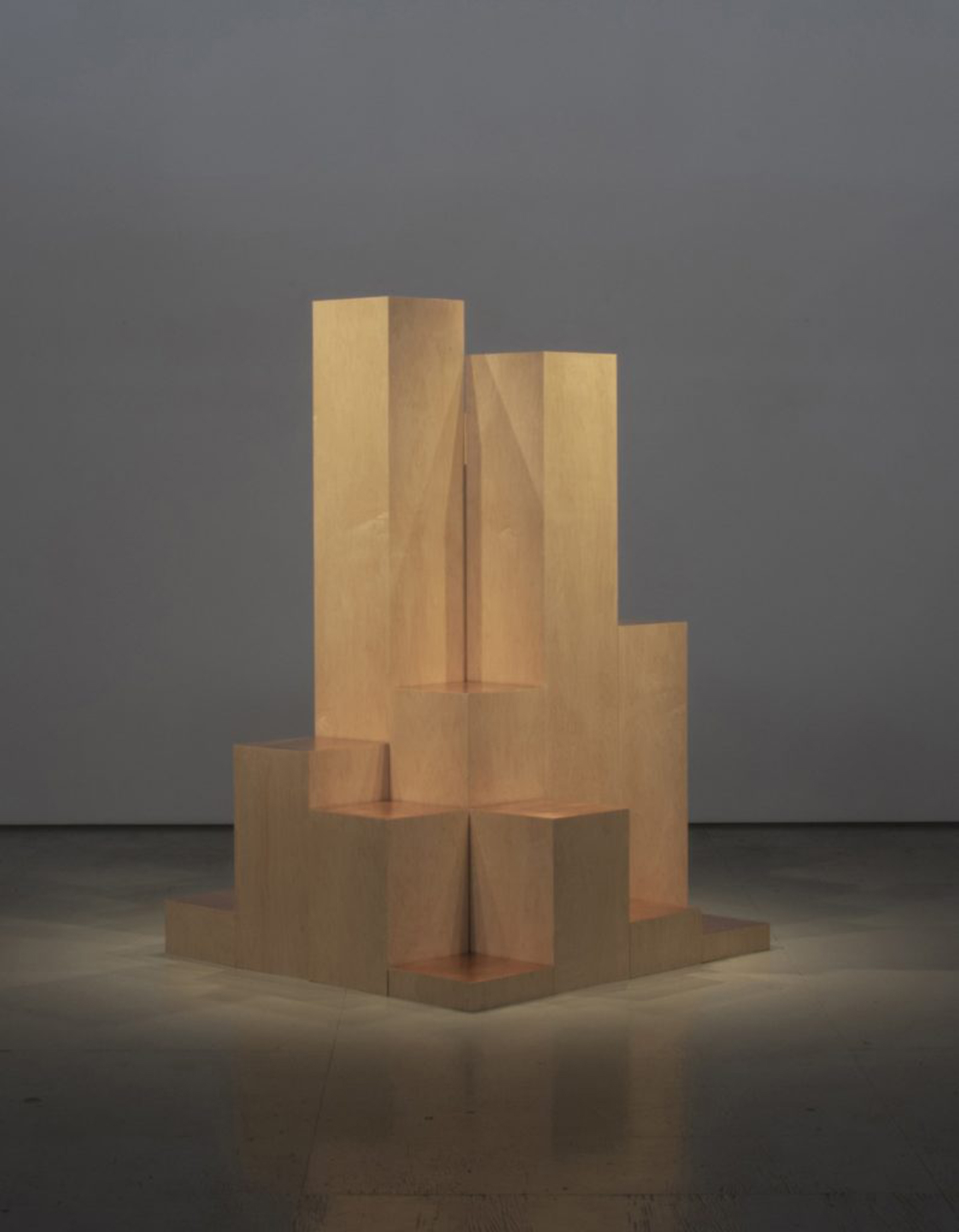 Monolithic wood sculpture with copper leaf.