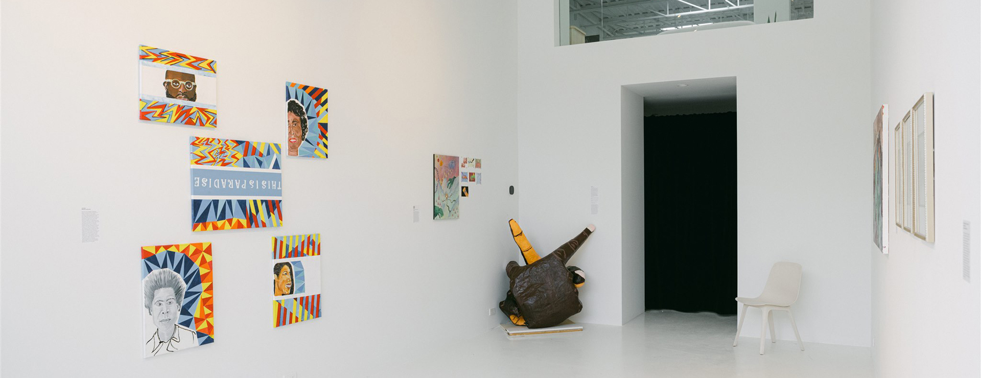 Gallery with colourful artwork in various mediums and white walls