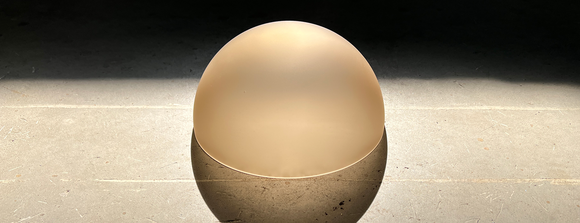 whisky coloured, frosted glass hemisphere in the studio