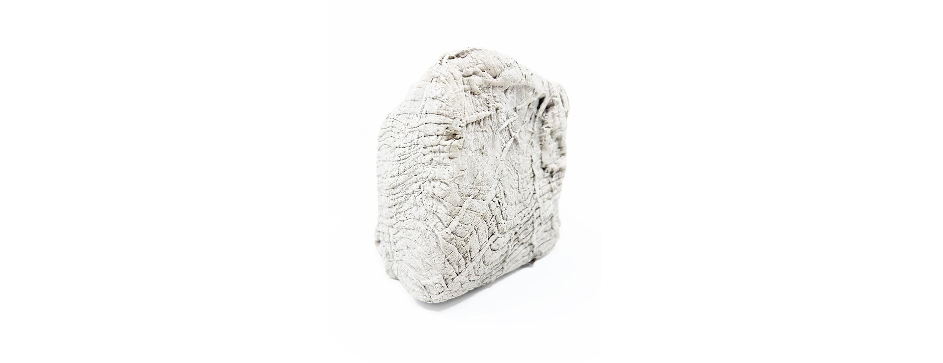 textured clay sculpture, white background.