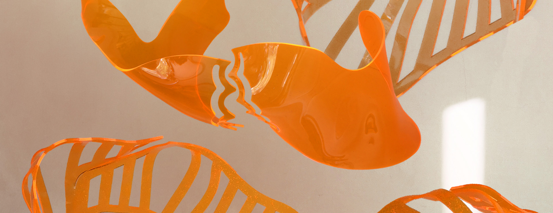 Orange acrylic bodices floating in space