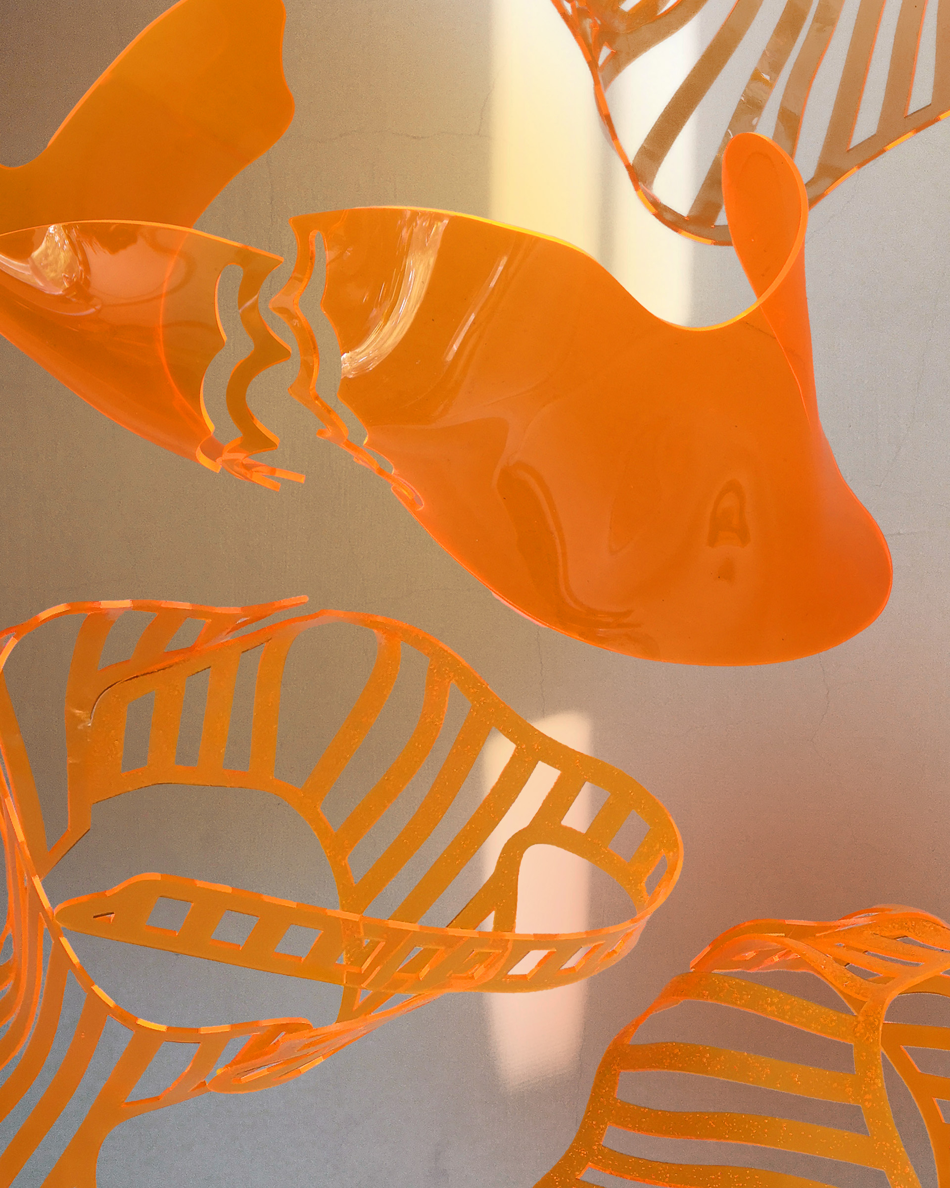 Orange acrylic bodices floating in space